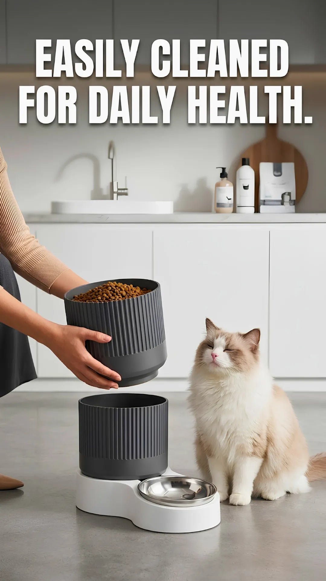 Cat sitting next to a pet food dispenser with text 'Easily cleaned for daily health' in a kitchen setting.