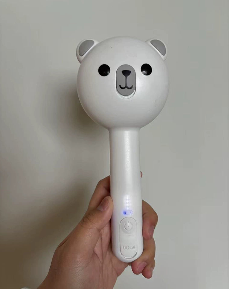 Handheld device shaped like a bear with a white background